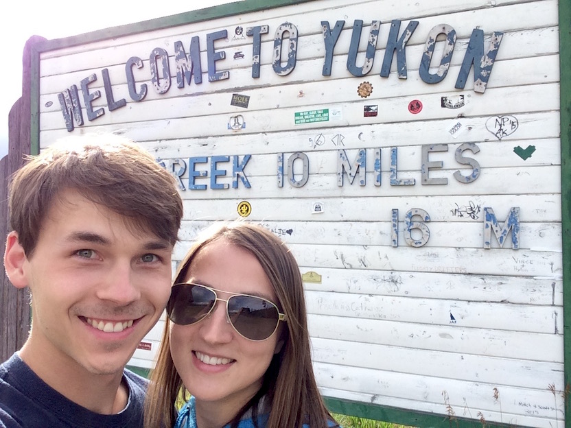 Vee and me standing in front of Yukon welcome sign